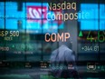 Monitors displaying stock market information are seen through the window of the Nasdaq MarketSite in the Times Square neighbourhood of New York.