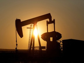 An oil pump jack pumps oil in a field near Calgary.