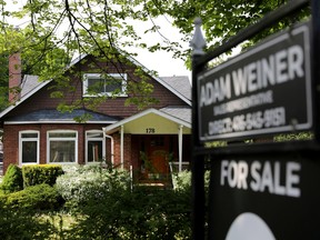 A realtor's sign outside a house for sale in Toronto on May 20, 2021.