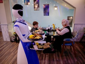 Robots deliver food to customers at a restaurant which recently opened in the city of Mosul, Iraq, November 16, 2021. Artificial intelligence is expected to grow at 20 per cent a year to US$90 billion by 2025, suggesting a 2.5 times expansion over the next five years.