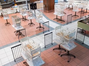 Chairs are shown stacked on tables at an empty food court in a mall in Montreal as the COVID-19 pandemic continues in Canada.
