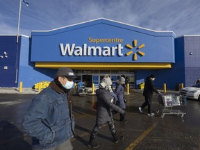 Shoppers outside a Walmart store in Montreal, Quebec, on Monday, Jan. 24, 2022. Premier Franois Legault says residents will have to show their vaccination passport to enter stores with floor surfaces of 1,500 square meters or more.