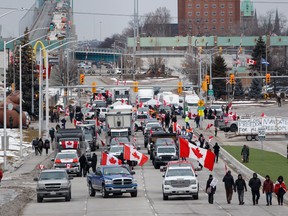 Protestors and supporters man a blockade at the foot of the Ambassador Bridge, sealing off the flow of commercial traffic over the bridge into Canada from Detroit on Thursday in Windsor.