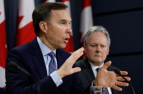 Finance Bill Morneau, left, and Bank of Canada governor Stephen Poloz attend a news conference in Ottawa on March 13, 2020 at the onset of the COVID-19 pandemic in which the Bank cut its key rate by 50 basis points.