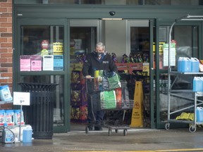 Shoppers leave Sobey’s grocery store in Oakville.