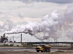 A dump truck works near the Syncrude oil sands extraction facility near the city of Fort McMurray, Alberta.