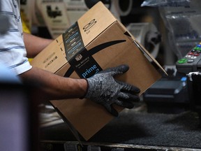 A worker assembles a box for delivery at the Amazon fulfillment center in Baltimore, Maryland.
