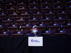 A Conservative party supporter holds a poster during the election night party in Oshawa, Ont., on Sept. 21, 2021.