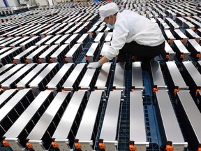 A worker with car batteries at a factory for Xinwangda Electric Vehicle Battery Co. Ltd, which makes lithium batteries for electric cars and other uses, in Nanjing in China's eastern Jiangsu province.