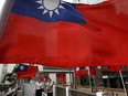 Taiwanese flags hang on display on a pedestrian overpass in Taipei, Taiwan.