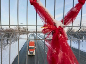 A truck drives under a pedestrian bridge on the route from the Ambassador Bridge border crossing in Windsor, Ont., on Feb. 14, 2022.