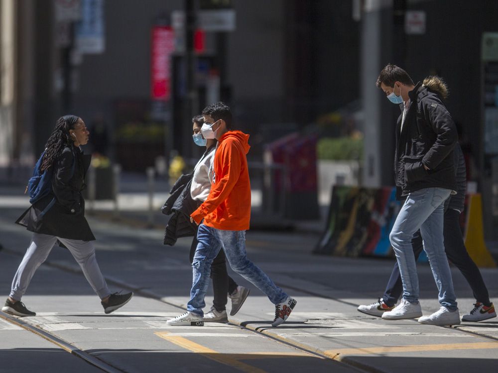 Pedestrians at the intersection of King and Yonge Streets in Toronto.