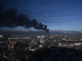 Black smoke rises from a military airport in Chuguyev near Kharkiv, Ukraine on Feb. 24, 2022.