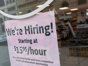 A 'We're Hiring' sign is displayed in the window of a store in Washington, DC, on Feb. 2, 2022.