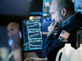 Traders work on the floor of the New York Stock Exchange.