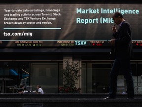 A pedestrian passes in front of the Toronto Stock Exchange in the financial district of Toronto.