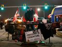 A DJ plays as protestors and supporters attend a blockade at the foot of the Ambassador Bridge, sealing off the flow of commercial traffic over the bridge into Canada from Detroit on Thursday in Windsor. As a convoy of truckers and supporters continues to occupy Ottawa's downtown, blockades and convoys have popped up around the country in support of the protest against Canada's COVID-19 vaccine mandate for cross-border truckers. 