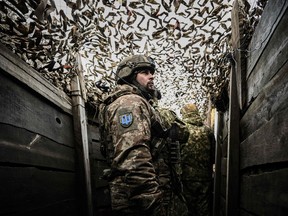 Ukrainian troops patrol the frontline outside the town of Novoluhanske, eastern Ukraine.