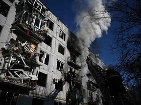 Firefighters fight a fire after bombings on the eastern Ukraine town of Chuguiv on Thursday, as Russian armed forces used rocket systems and helicopters to attack Ukrainian position in the south, the border guard service said.