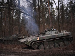 Ukrainian infantry combat vehicles stand guard on the outskirts of Kyiv on Thursday.