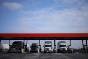 Transport trucks fuel up at a truck stop in the United States.