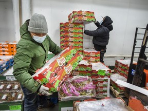 Workers handle cases of fruit at the Ontario Food Terminal.