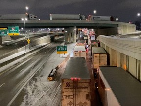 Truckers stand in line as they block the Ambassador Bridge (not pictured) on the I-75 and I-96 highways in Detroit, Michigan.