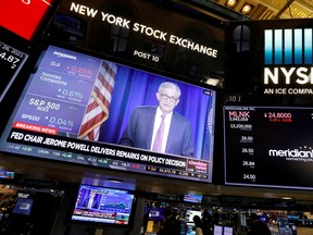 A screen displays the Federal Reserve Chair Jerome Powell on the trading floor at New York Stock Exchange