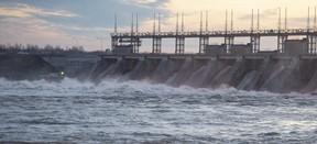 Water rushes through a hydro electric dam in Carillon, Quebec. Industrial customers in Quebec pay anywhere from 30 to 80 per cent less for electricity than they would in Ontario.