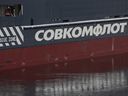 The logo of Russian state shipping company Sovcomflot on a vessel moored in central St. Petersburg, Russia.