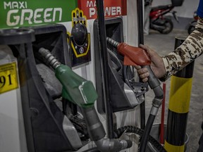A worker loads gasoline at a gas station, a day before a huge price increase on petroleum products is implemented, on March 7, 2022 in Quezon City, Metro Manila, Philippines.