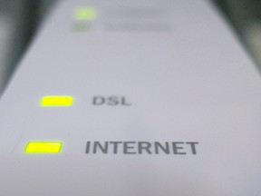 Internet and DSL lights are illuminated on a modem in Chelsea, Que.