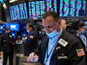 Traders work on the floor of the New York Stock Exchange in New York City, U.S.