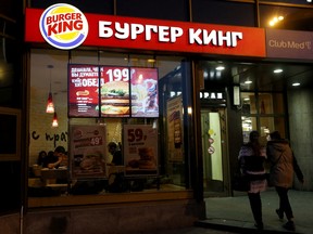 Women walk outside a Burger King restaurant in Moscow, Russia.