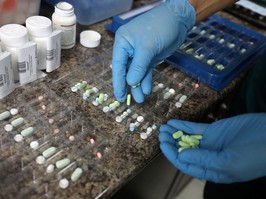 A pharmacist counts prescription drugs at the at the CentreTown Pharmacy in Ottawa.