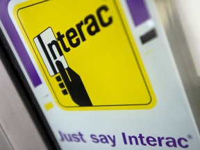 A Interac sign on a business storefront in North Vancouver, B.C.