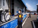 A staff member from the Apollo Group preparing to refuel a hydrogen car at the company's hydrogen gas station in Fukushima City, Japan.
