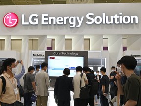 Visitors look at a booth of LG Energy Solution during the InterBattery 2021 exhibition at COEX in Seoul.