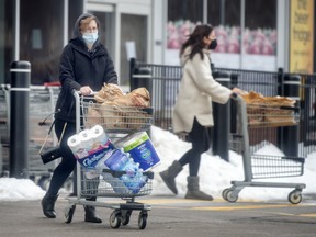 Shoppers leave Longo’s grocery store in Oakville.