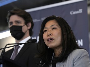 Minister of Economic Development Mary Ng speaks as Prime Minister Justin Trudeau listens at Bayview Yards in Ottawa.