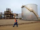 An oilfield worker walks past the Statoil oil sands facility near Conklin, Alta.