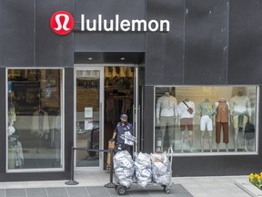 A FedEx delivery person leaves a Lululemon store in Toronto's Yorkville area during the COVID 19 pandemic.