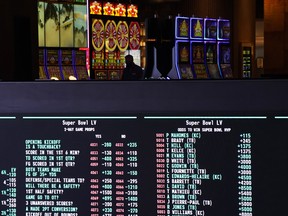 Betting odds for NFL football's Super Bowl 55 are displayed on monitors at the Circa resort and casino sports book in Las Vegas.
