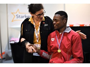 Tani Austin, Chief Philanthropy Officer at Starkey (left), greets a Special Olympics athlete in Abu Dhabi, United Arab Emirates.
