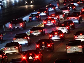 Cars, trucks, and sport utility vehicles drive on the 405 Freeway during rush hour traffic in Los Angeles. The IEA says its plan - which includes lower speed limits, working from home, car-free days in cities, cheaper public transport and more carpooling - could cut oil demand by 2.7 million barrels a day within four months.