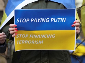 A demonstrator holds a sign during a rally in support of Ukraine in Brussels, Belgium.