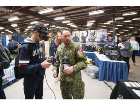 A student visitor participates in a Try-A-Trade® and Technology activity at the Canadian Armed Forces booth at the 25th SCNC, in Halifax, in May 2019.