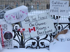 Signs of support for truck drivers participating in a protest opposing vaccine mandates near Parliament Hill on Feb. 18, 2022.