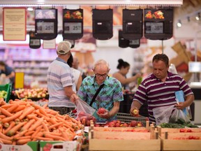 Customers select apples in a food market in Russia in 2014.