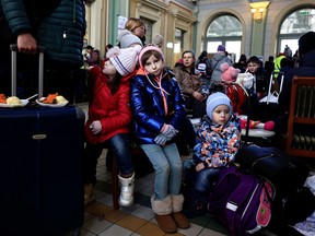 Girls rest at a train station, after fleeing Russia's invasion of Ukraine, in Przemysl, Poland, March 17, 2022.